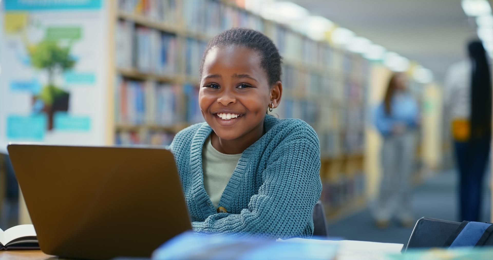 Laptop, elearning and black girl in library, portrait and online reading with connection. Development, elementary student or child with pc, studying or research for project, education or website info