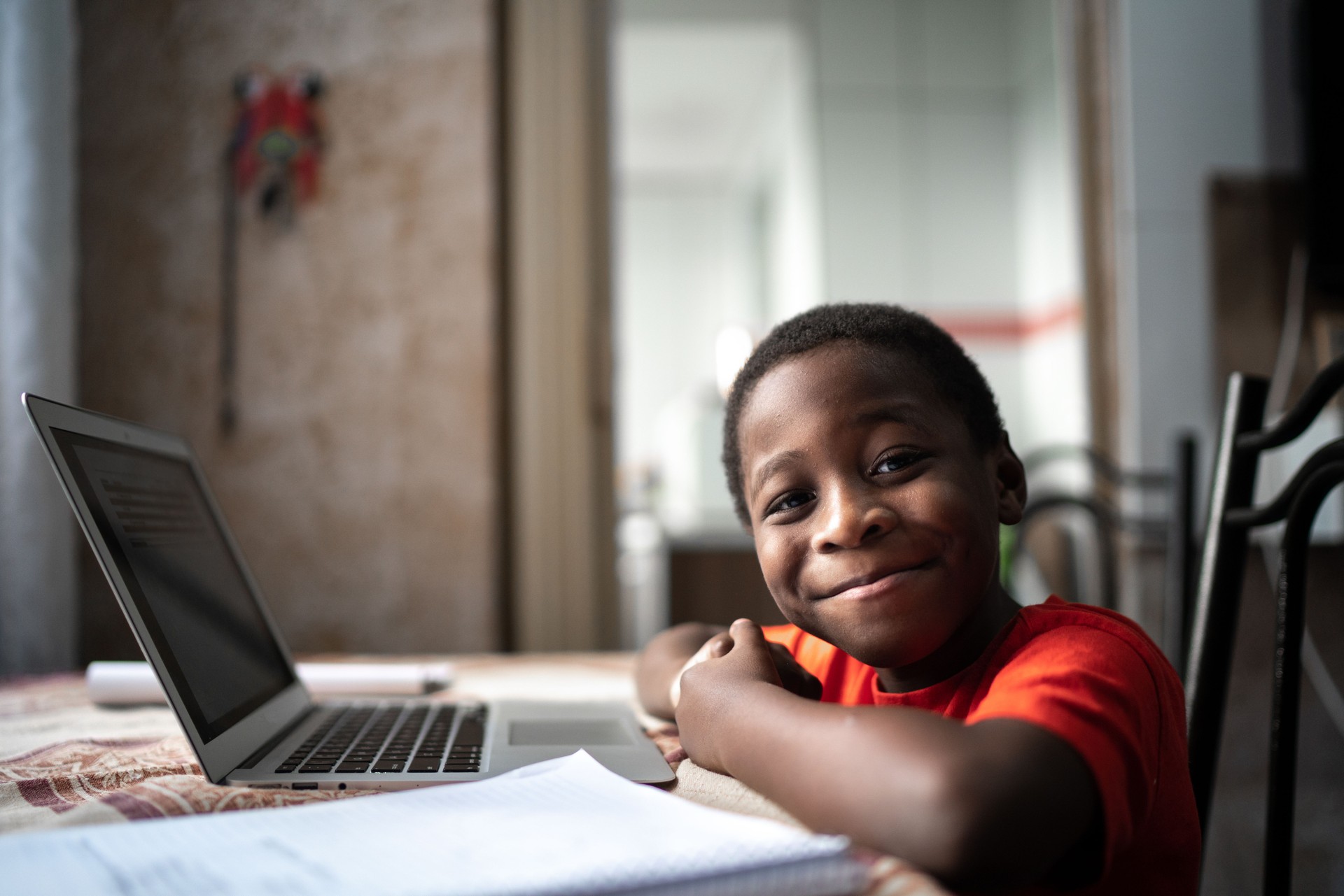 Portrait of a child with laptop on a online class at home